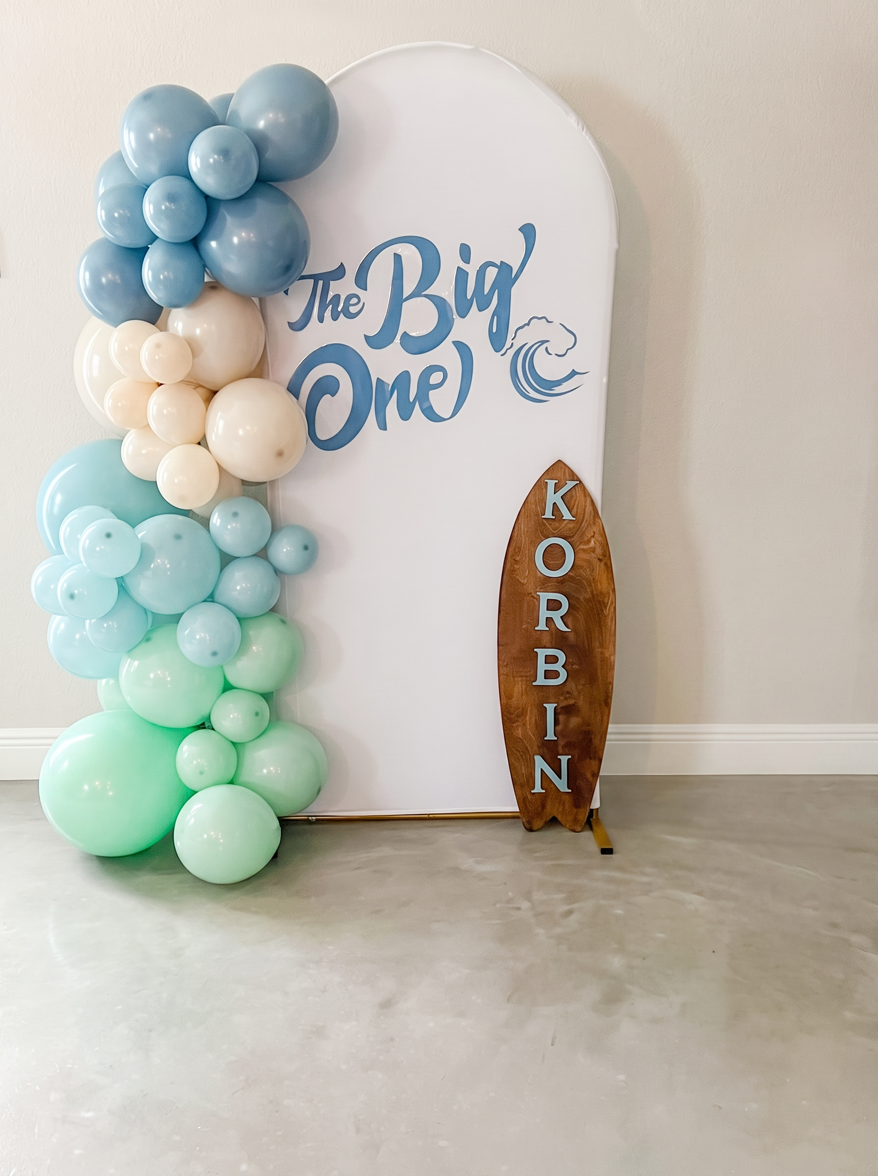 Blue and mint surf-themed first birthday balloon garland